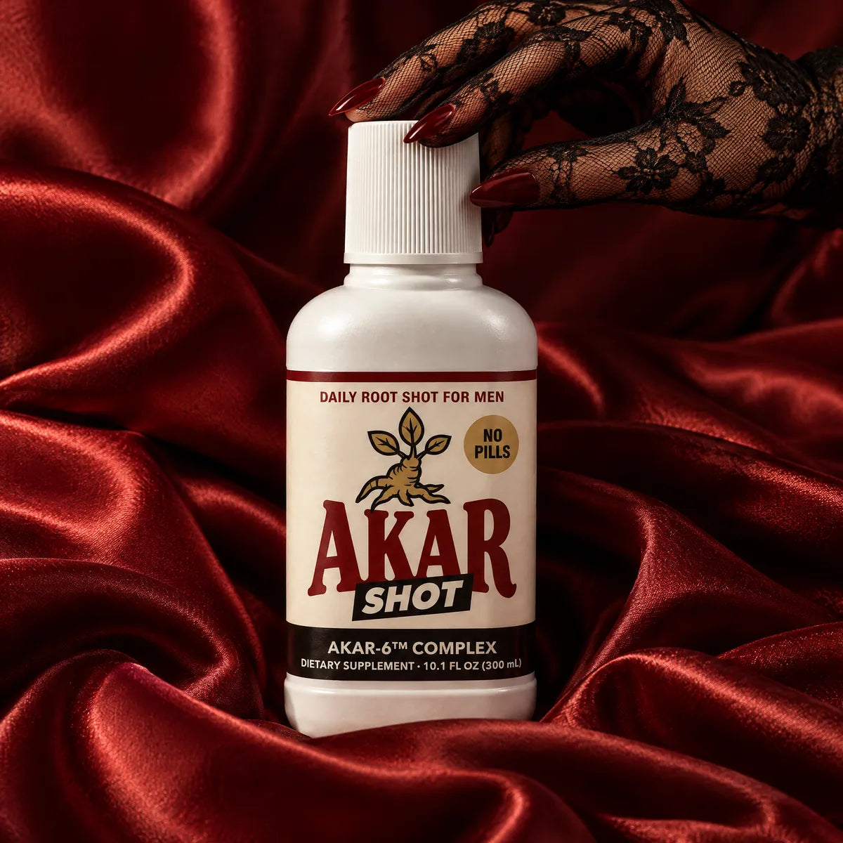 AKAR SHOT nestled in deep red satin as a hand in a black lace glove reaches for the cap